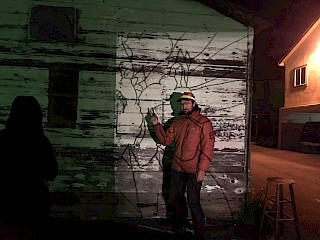 The artist started by projecting a sketch onto the side of the building at night and tracing it with charcoal. gallery image